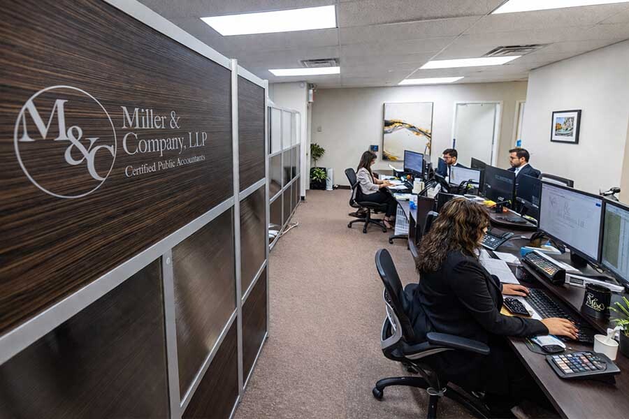 accounting team working on small business bookkeeping and financial records organization in NYC office