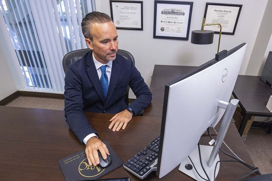 NYC CPA consulting client on back taxes owed and IRS tax debt resolution at Miller & Company LLP office