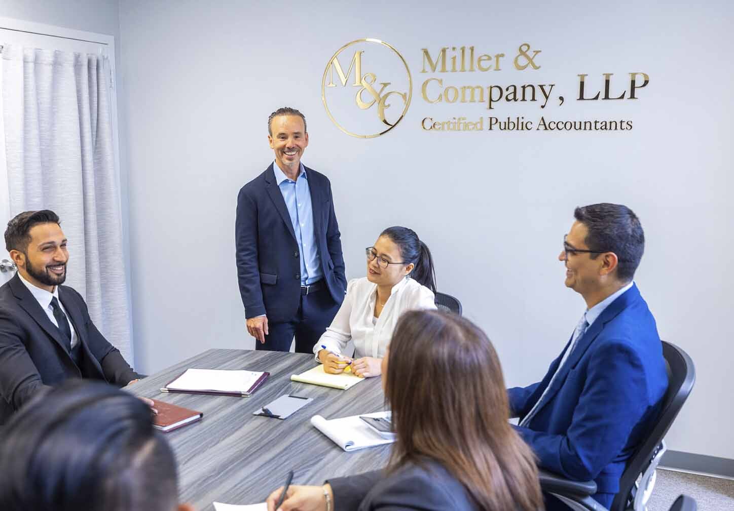 Miller & Company CPA advisory team discussing business tax planning in a conference room.