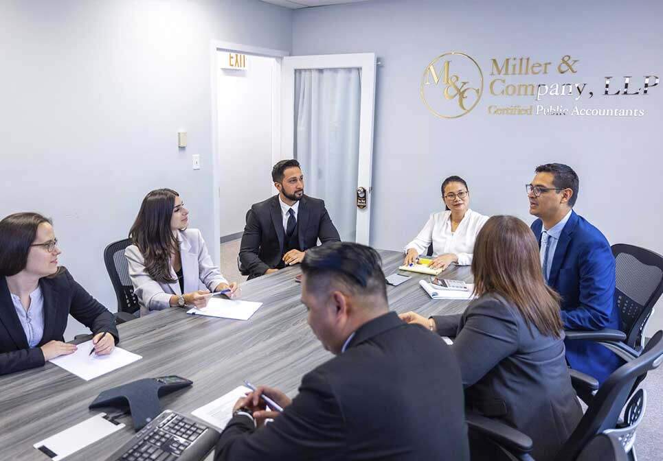Business owner reviewing financial records with a business tax CPA at Miller & Company, LLP