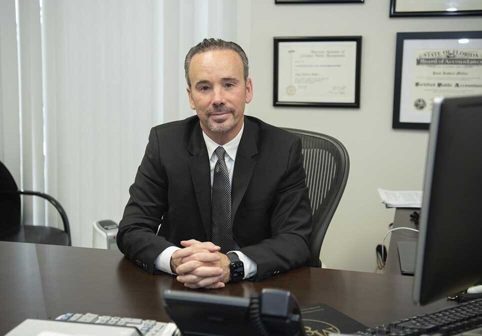 Paul Miller, CPA reviewing tax minimization strategies with a high-income individual and business owner